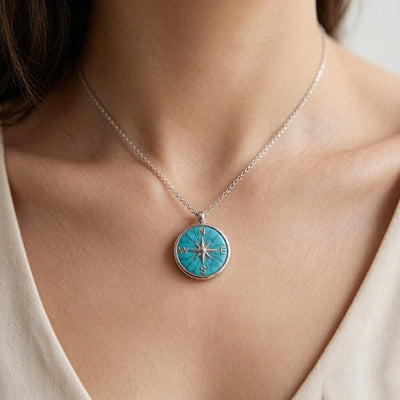 Turquoise compass necklace worn on neckline - lifestyle